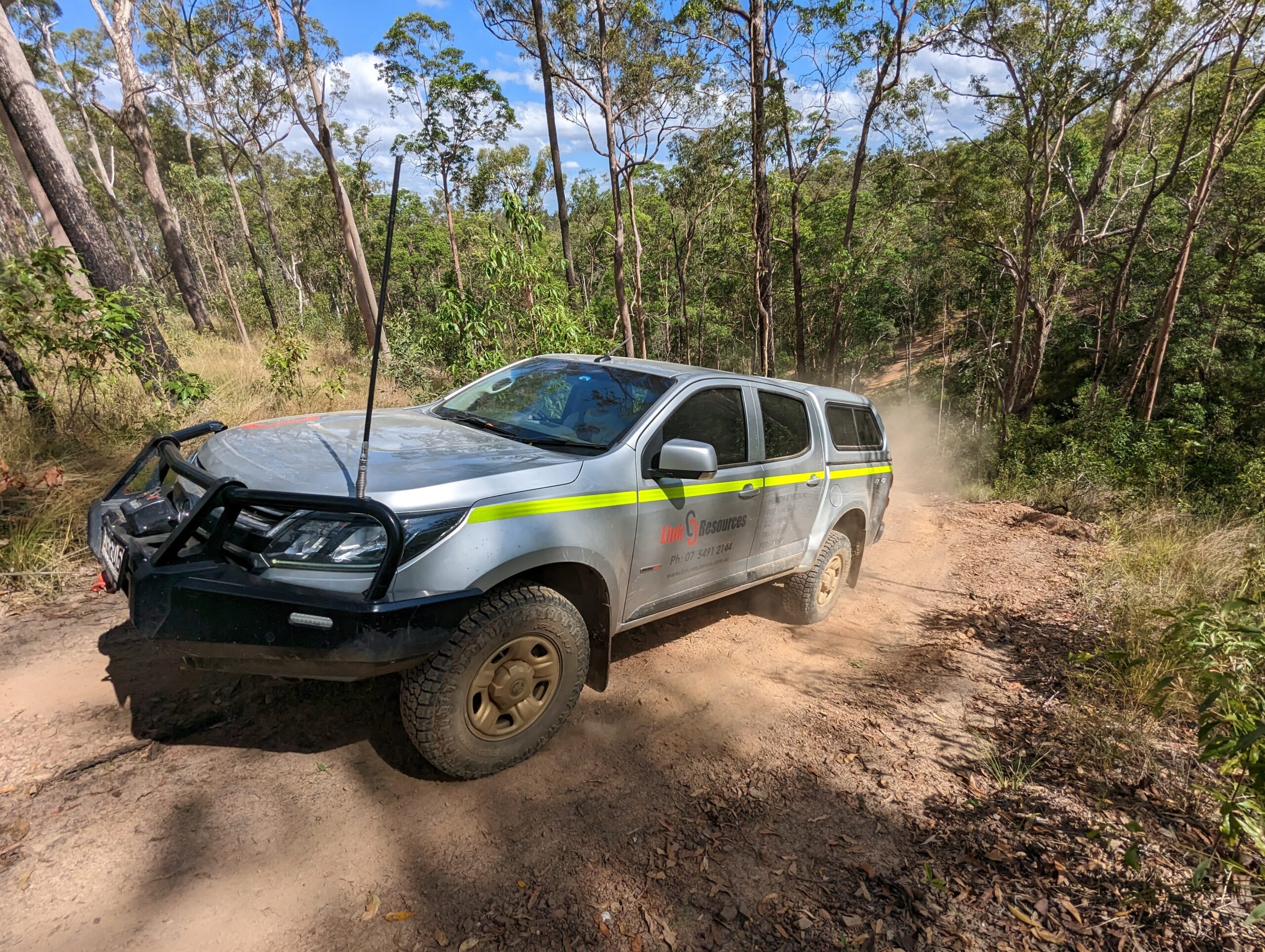 Silver Australian 4wd and advanced driver education ute driving up a dirt track in the bush